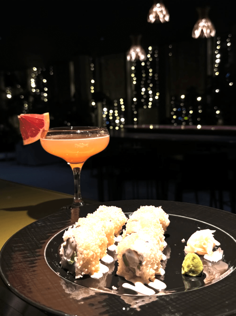 Craft cocktail and gourmet sushi served at a rooftop bar in Tirana