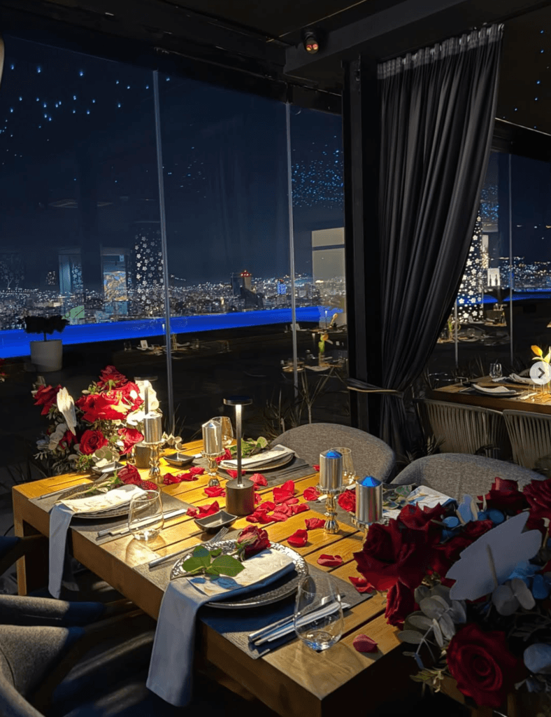 Elegant rooftop restaurant with candlelit dining and panoramic views over Tirana