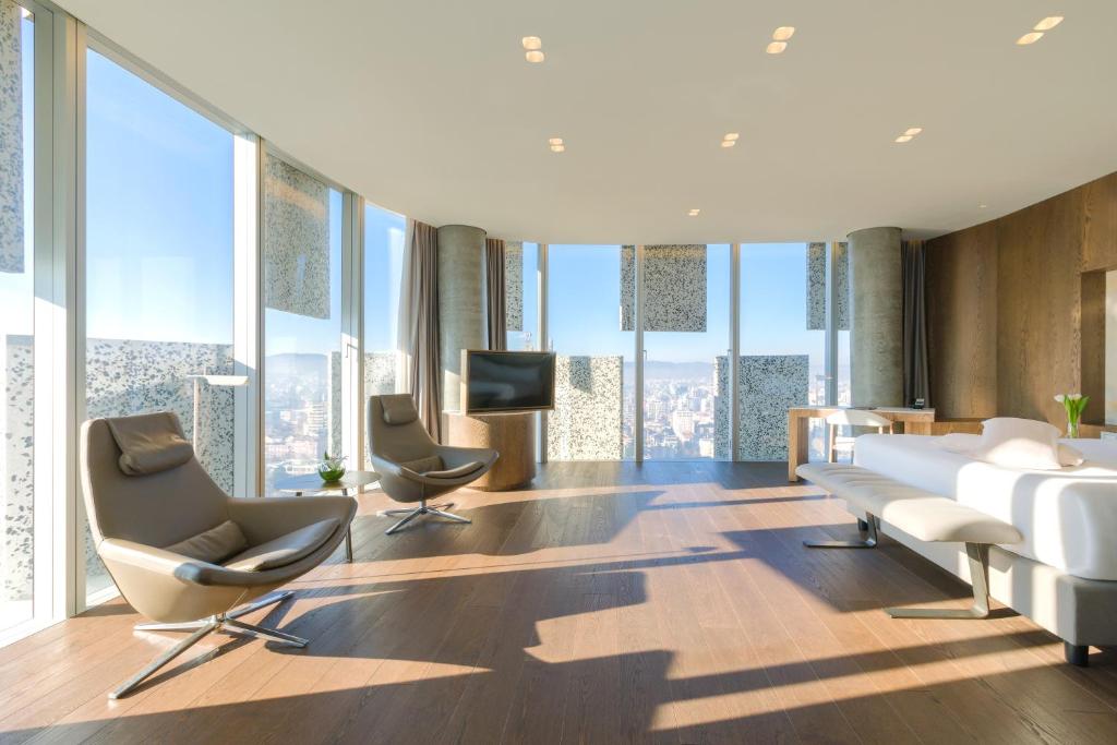 Accessible guest room at Maritim Hotel Plaza Tirana with wide open floor space, large windows, and modern furnishings.