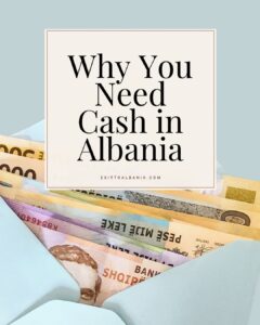 A fan of Albanian Lek banknotes tucked into a light blue envelope against a muted blue background. A central cream-colored square features bold black text that reads "Why You Need Cash in Albania," with the website "exittoalbania.com" printed in small red letters below.