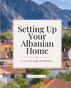 Guide cover titled Setting Up Your Albanian Home with a background of traditional red-tiled roof houses.