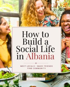Pinterest graphic reading "How to Build a Social Life in Albania" featuring a diverse group of friends enjoying a meal together.